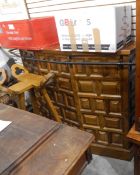 A modern panelled oak bowfront bar with metal rail, and a pair of bar stools,