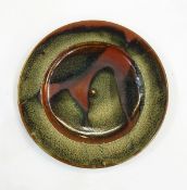 Ray Finch Winchcombe poured-glaze charger with mottled green slip over rust groud, stamped to base,