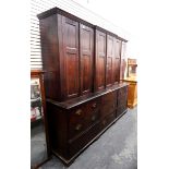 Large 19th century oak breakfront housekeeper's cupboard with three panelled cupboards enclosing