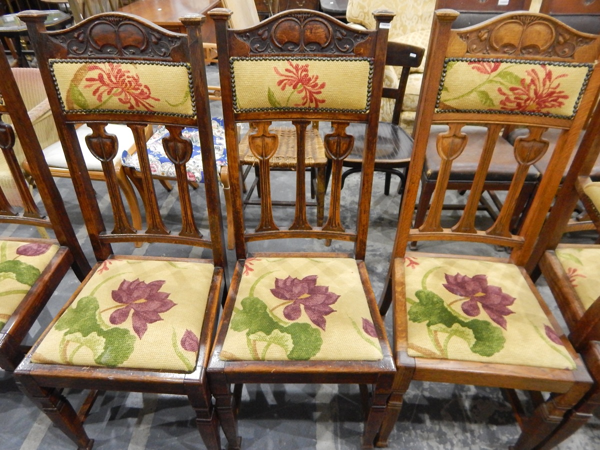 Set of six Edwardian dining chairs in the Arts & Crafts style, with hump carved crest rail,