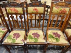 Set of six Edwardian dining chairs in the Arts & Crafts style, with hump carved crest rail,