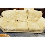 Two-seater settee with loose squab cushions, upholstered in a gold-coloured fabric,