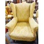 Old wing armchair with gold floral mockette upholstery,