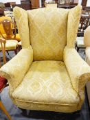 Old wing armchair with gold floral mockette upholstery,