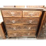 Victorian carved oak chest of drawers with moulded edged top,