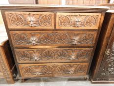 Victorian carved oak chest of drawers with moulded edged top,