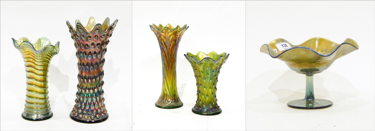 Four green carnival glass vases, all of flared design with wavy rims,