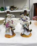 A pair of Dresden porcelain table candlesticks, modelled with a shepherd and shepherdess with sheep,