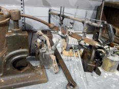 Wooden clamp, gas lamp, measuring chain in metal bucket and a metal shelf, various paraffin lamps,