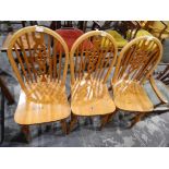 Set of three pine wheelback kitchen chairs with solid seats,