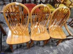 Set of three pine wheelback kitchen chairs with solid seats,