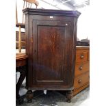 19th century oak corner cupboard with fluted sides, panel door enclosing three shaped shelves,