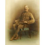 Early 20th century coloured portrait photograph of a seated soldier in army uniform,