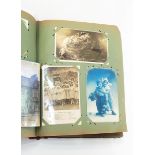 Postcard album and contents including comical, topographical and portrait postcards,
