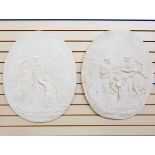 Pair of plaster wall medallions of oval form,