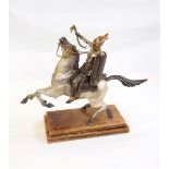 Silvered figure of a warrior on horseback, on a stepped marble plinth with inscribed bronze plaque,