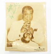 Signed ABC photograph of Louis Armstrong playing the trumpet,