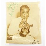 Signed ABC photograph of Louis Armstrong playing the trumpet,