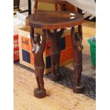 Carved hardwood stool, probably African, the circular seat decorated with a scene of hunters,