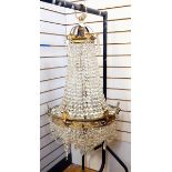 20th century brass electrolier, three-tier with graduated cut glass droplets,