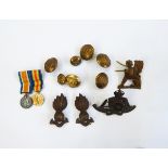 Three Royal Artillery cap badges, assorted Royal Artillery buttons, a Sphinx cap badge,