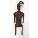 Carved hardwood articulated tribal figure, possibility an Indonesian fertility doll,