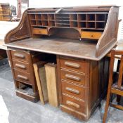 20th century oak piano-shaped roll-top desk, the interior fitted with small drawers,