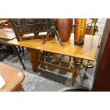 Oak rectangular top dining table with trestle supports united by central stretcher,