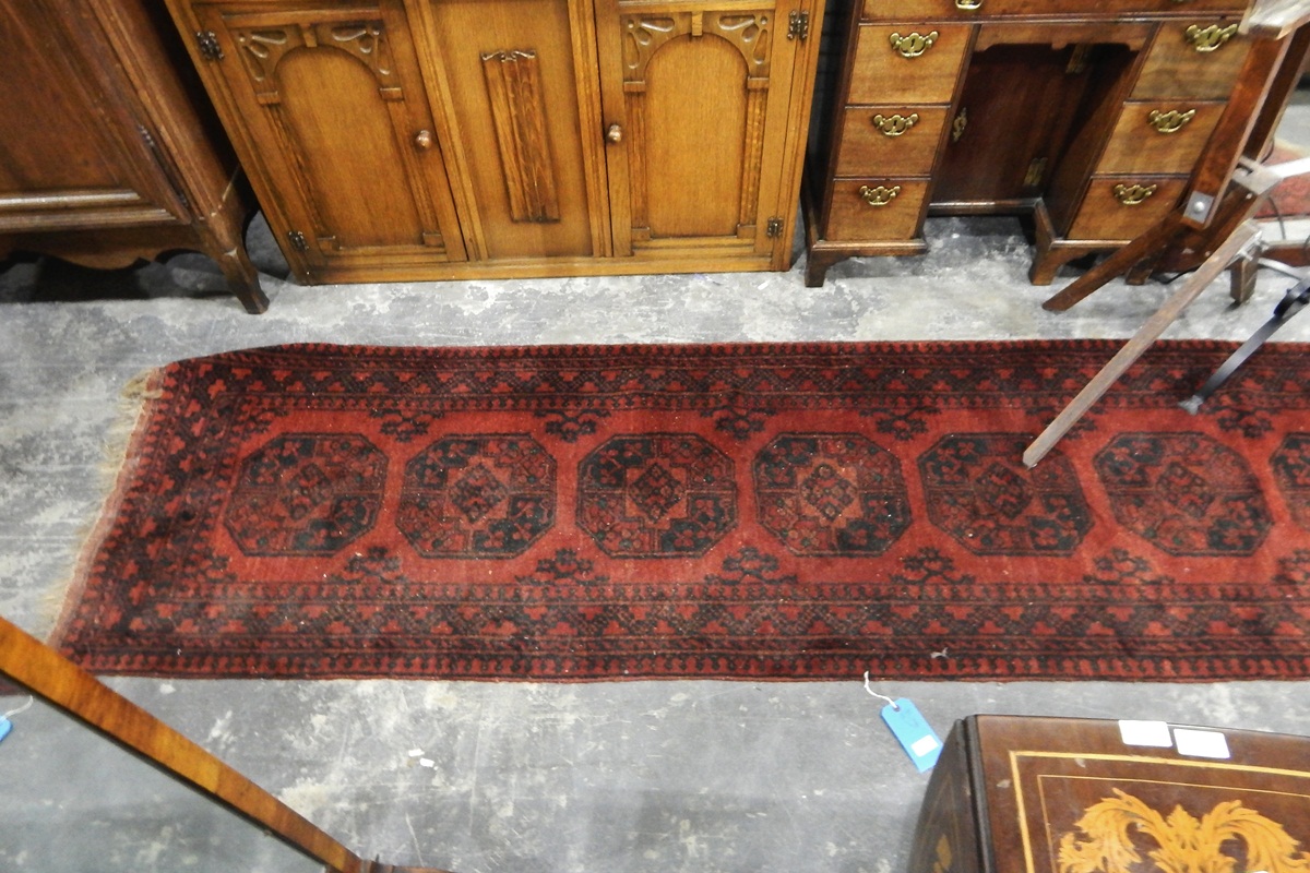 Turkish-type runner of dark red ground, geometric medallions within multi-border,