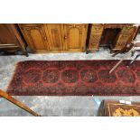 Turkish-type runner of dark red ground, geometric medallions within multi-border,