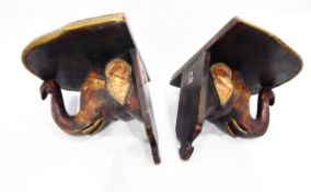 Pair of wall shelves in the form of carved wooden elephant heads,