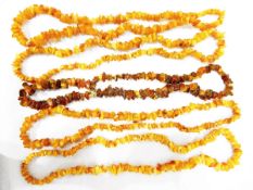 Four strings of yellow amber nugget beads and another amber nugget necklace