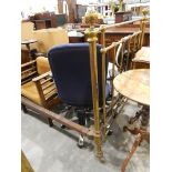 Old brass bedstead raised on castors, with bed irons,