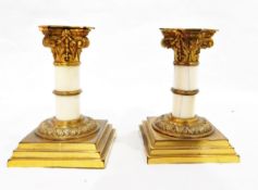 Pair of early 20th century ormolu and ivory Corinthian column candlesticks on square stepped bases