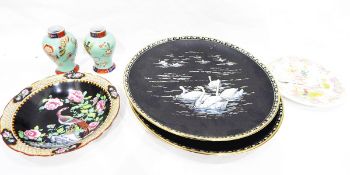 Pair of Minton porcelain black ground chargers decorated with swans,