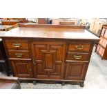 Late Victorian panelled oak side cupboard, the central moulded front door enclosing two shelves,