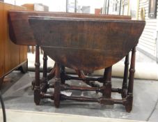 18th century oak oval top gateleg table on turned legs united by stretchers,