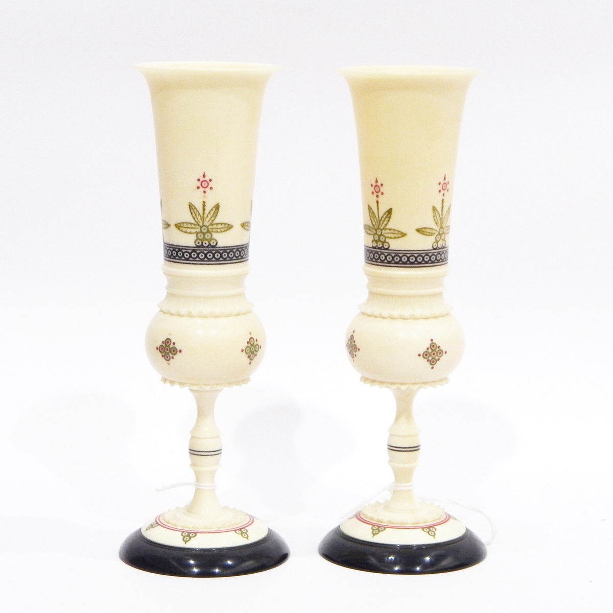 Pair of early 20th century Indian painted and turned ivory goblets, each with everted rims,