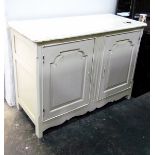 White painted dwarf two-door cupboard enclosed by panelled doors,