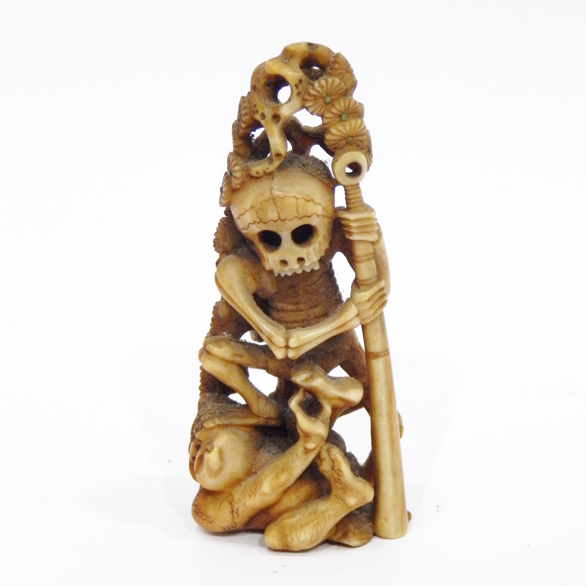 Late 19th/early 20th century Japanese marine ivory model of a skeleton trampling on an oni,