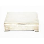 Silver cigarette box, Birmingham 1956, of engine turned rectangular form, on stepped feet,