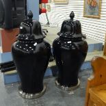 Pair of large decorative jars and covers of baluster form, with a black glaze,