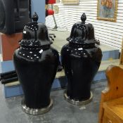 Pair of large decorative jars and covers of baluster form, with a black glaze,