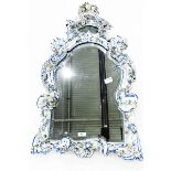 Meissen style porcelain wall mirror in the shape of a shield, with floral and scroll decoration,