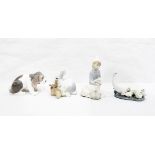 Four Lladro models, one of kneeling boy with a sheep, another of a rabbit,