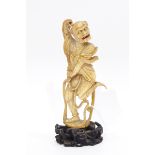 Late 19th century Chinese carved ivory figure of a dancing oni, on carved wooden base,