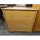 Contemporary pale beech chest of three long drawers, with elegant turned wooden handles,