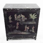 Oriental lacquered cabinet, overall decoration of figures around a gaming board with plants,