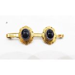 Gold-coloured metal banded onyx brooch,