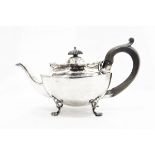 Edwardian silver teapot by Nathan & Hayes, Chester 1901 of panelled oval form on four scroll feet,